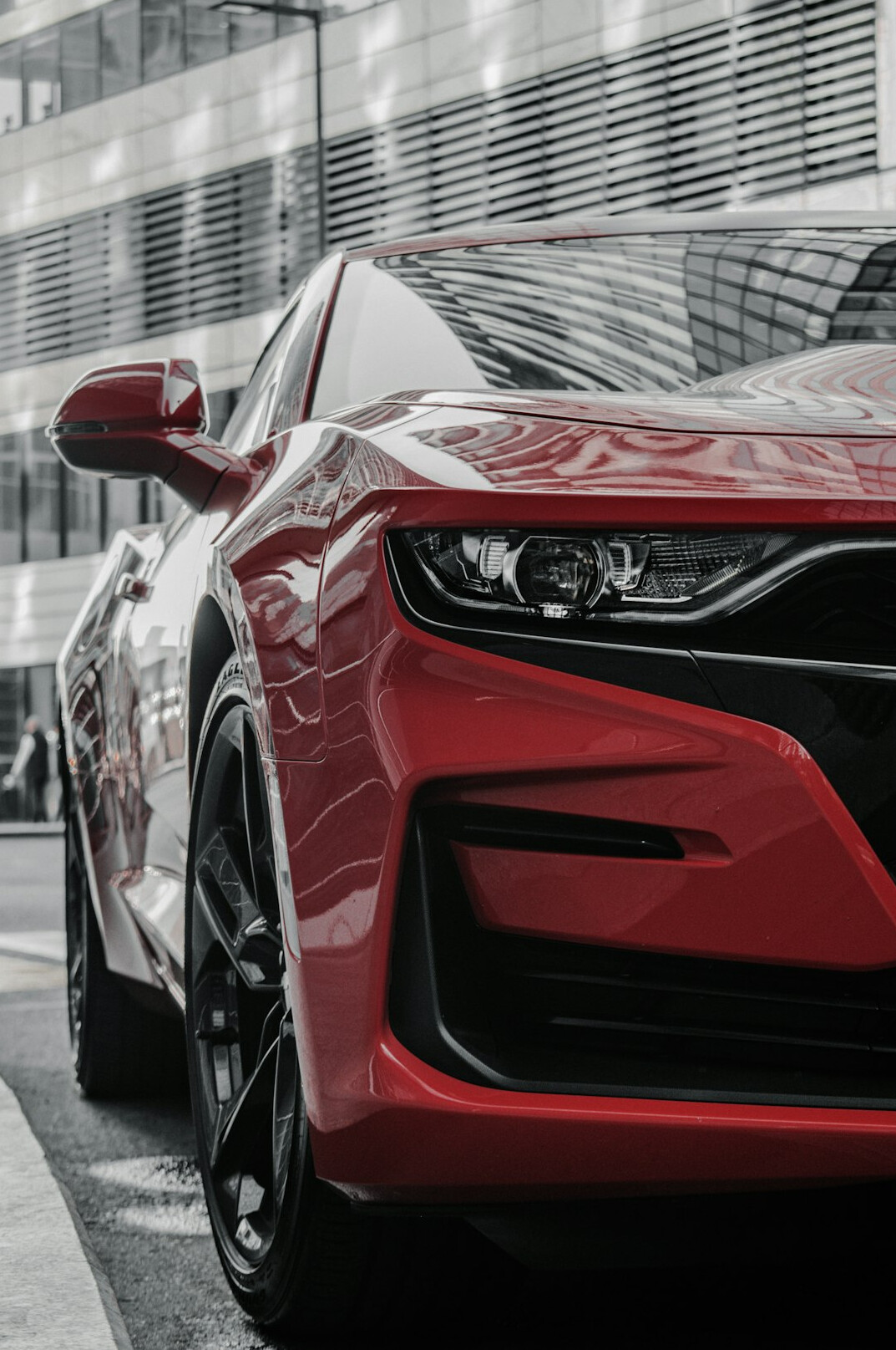 Red sports car front bumper close-up