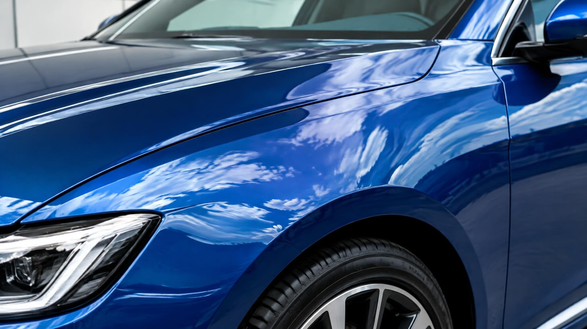Glossy painted car body with reflections