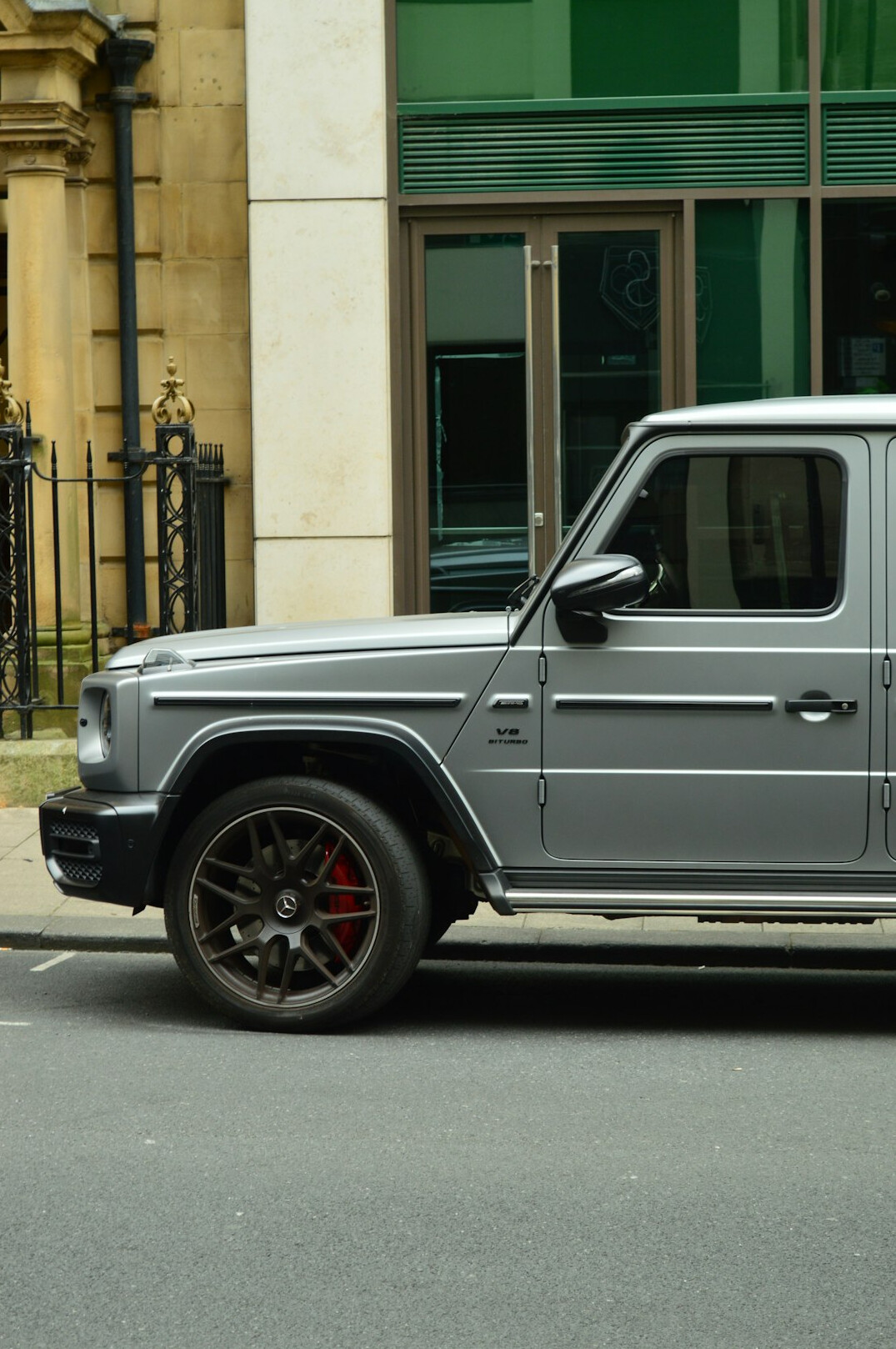 Silver sports car parked outdoors, side view